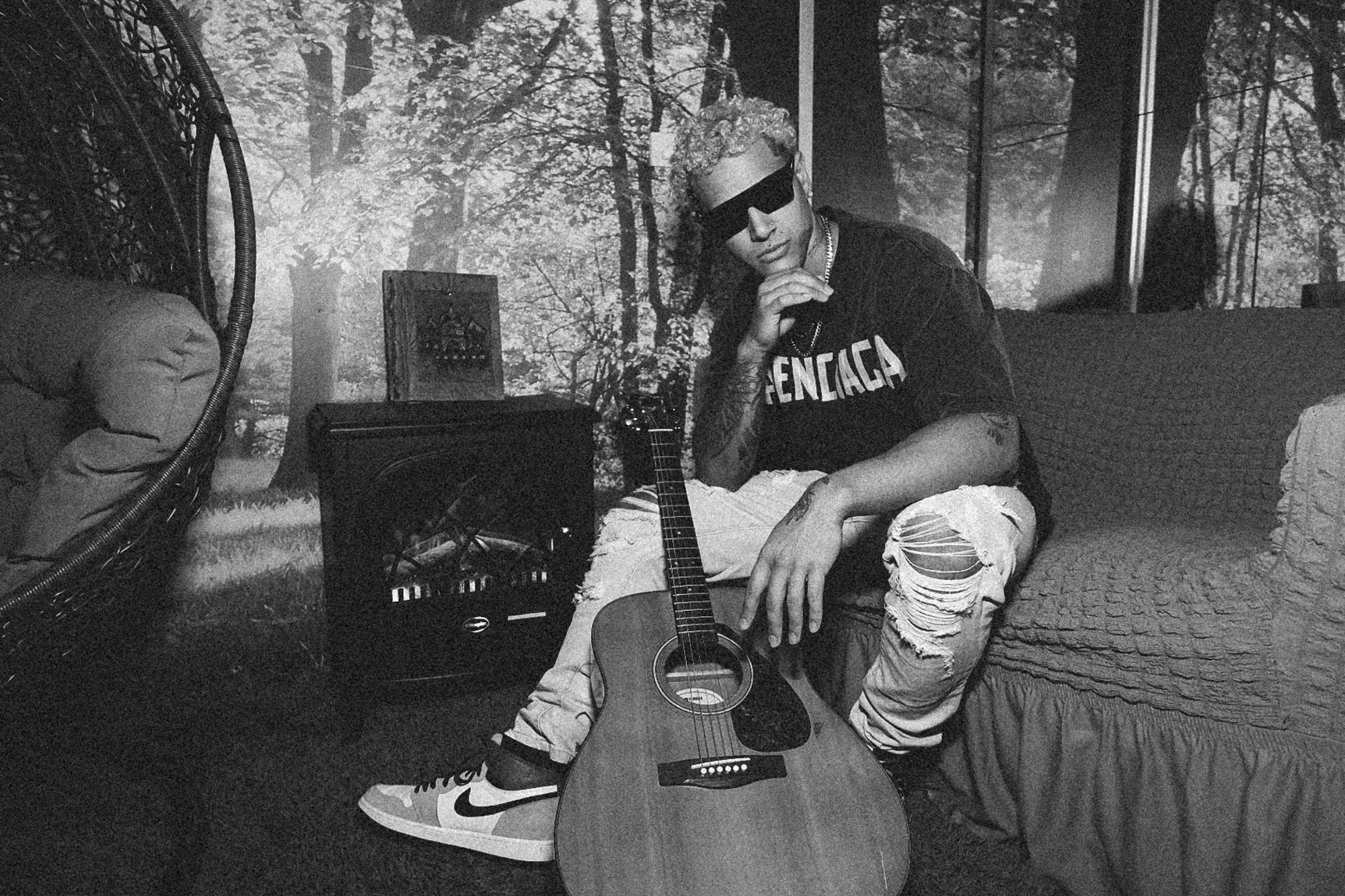 Black and white, acoustic guitar in a hanging chair