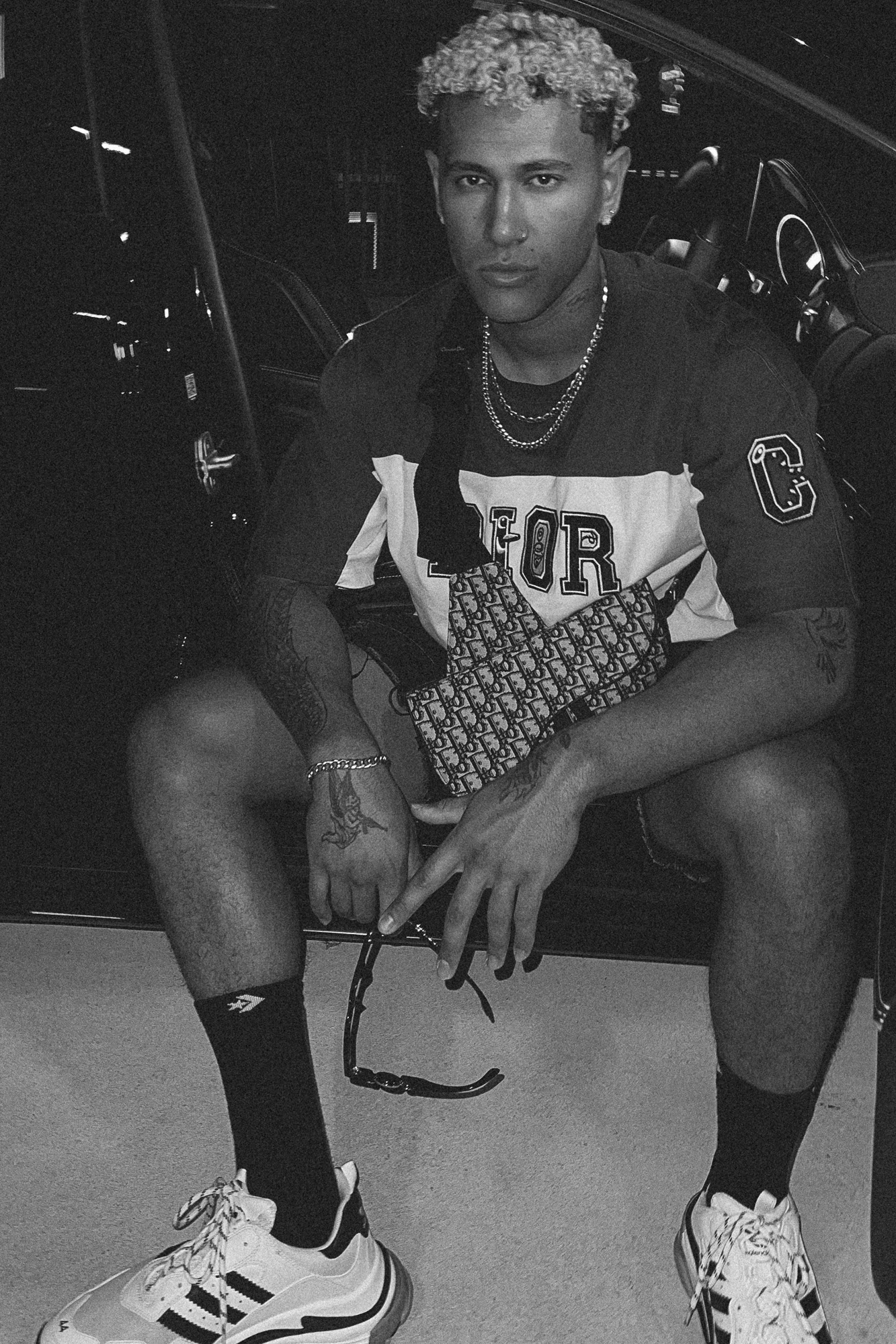 Black and white streetwear portrait, seated